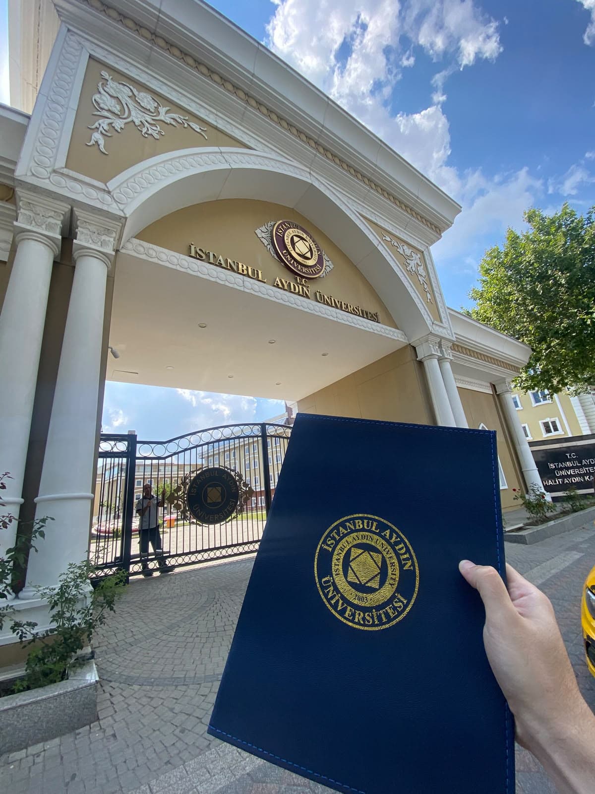 A closed diploma folder at the entrance to İstanbul Aydın University